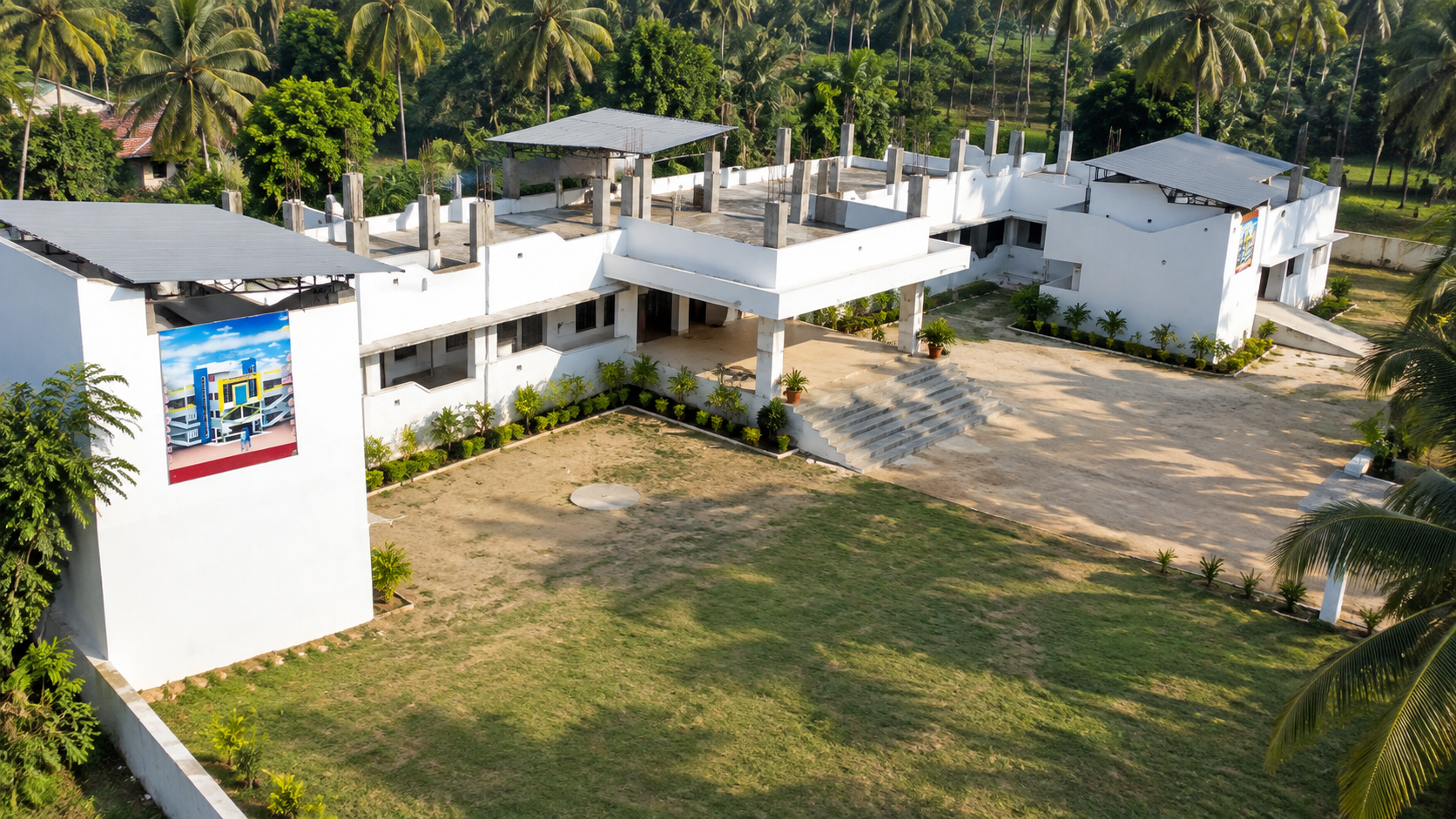 Aerial elevated perspective of Kalaivani Matriculation School building and open grounds in Kottur Thottam